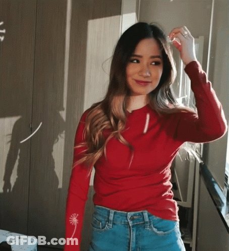 Woman In Red Sweater And Blue Jeans By Window GIF