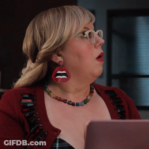 Woman In Red Sweater And Lip Earring Looking At Laptop GIF