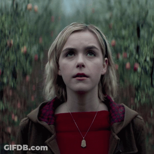Woman In Red Sweater And Necklace Looking Up GIF