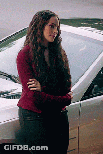 Woman In Red Sweater Beside Silver Car GIF