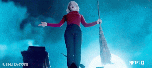 Woman In Red Sweater Flying With Broom GIF
