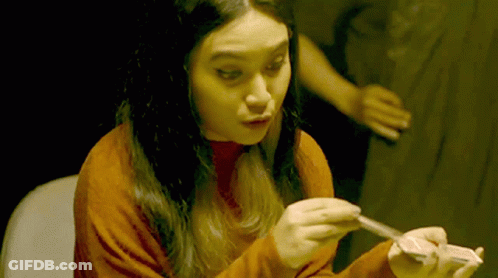 Woman In Red Sweater Holding Card GIF