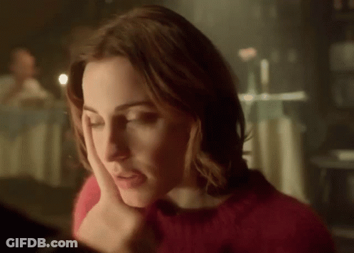 Woman In Red Sweater Looking Down GIF