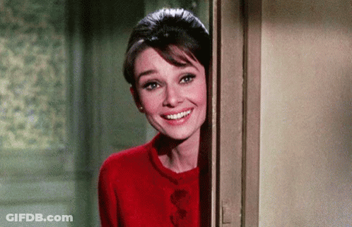 Woman In Red Sweater Peeking Out Of Doorway GIF