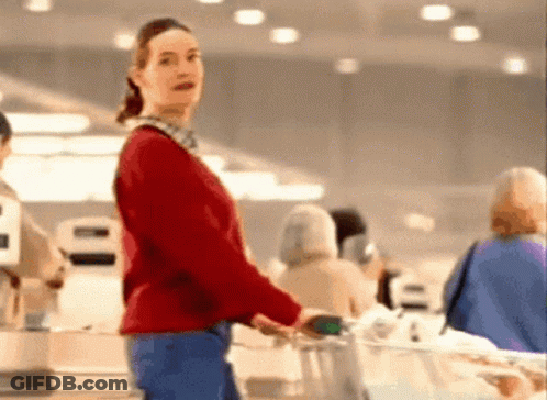 Woman In Red Sweater Pushing Grocery Cart GIF
