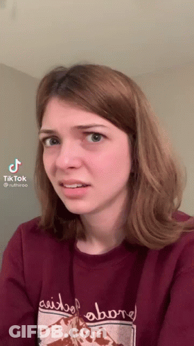 Woman In Red Sweater Saying Above Making Funny Face GIF
