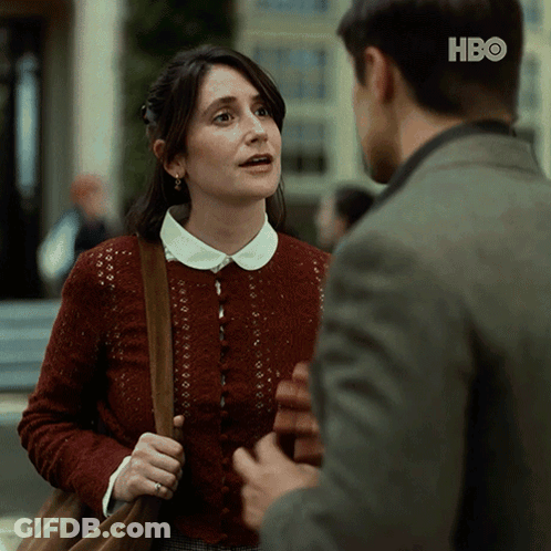 Woman In Red Sweater Talking To Man In HBO Suit GIF