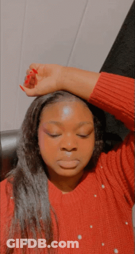 Woman In Red Sweater With Pearls Hand To Forehead GIF