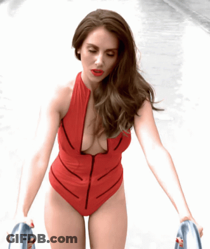 Woman In Red Swimsuit With Zipper Walking Down Sidewalk GIF