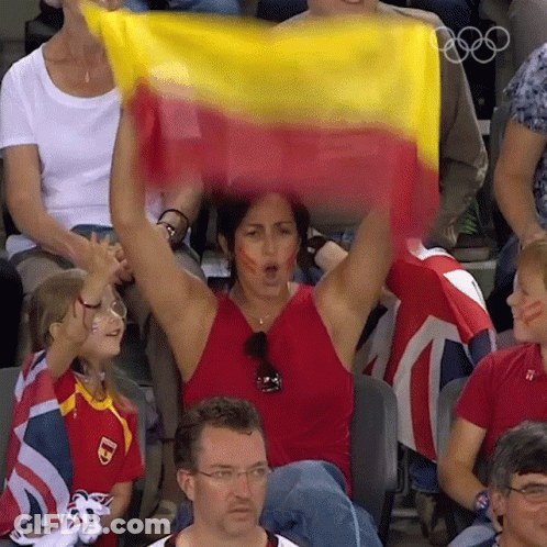 Woman In Red Tank Top Holding Yellow And Red Flag GIF