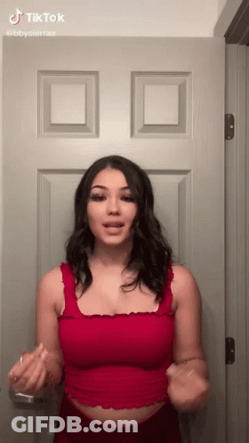 Woman In Red Tank Top Making Funny Face GIF
