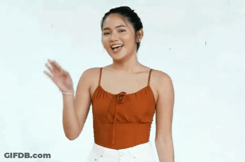 Woman In Red Tank Top Smiling And Waving GIF