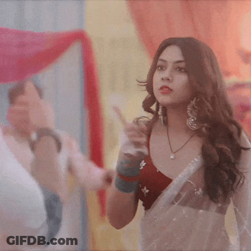 Woman In Red Top And White Saree Pointing GIF