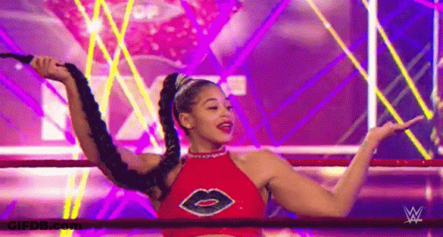 Woman In Red Top Holding Whip In Ring GIF