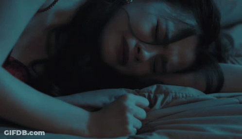 Woman In Red Top Laying On Bed GIF