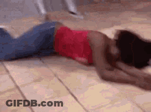 Woman In Red Top Laying On Floor GIF