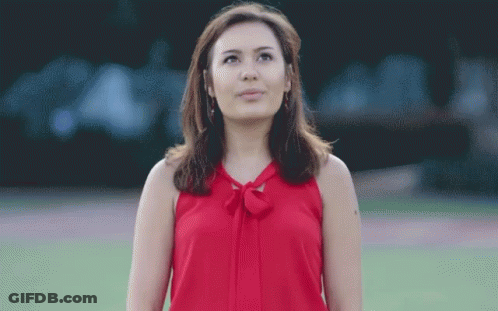 Woman In Red Top Looking Up GIF