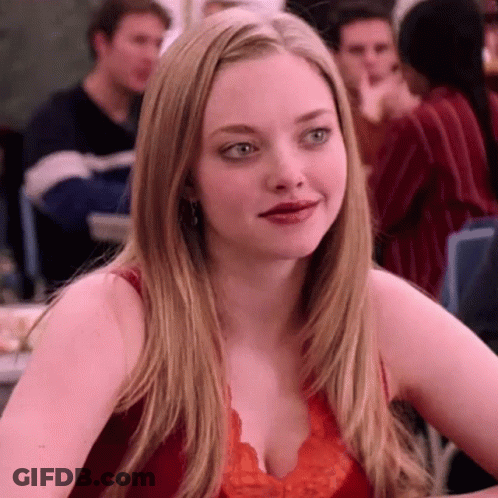 Woman In Red Top Sitting Crowded Room GIF