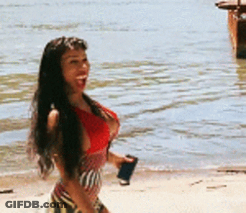 Woman In Red Top Walking On Beach GIF