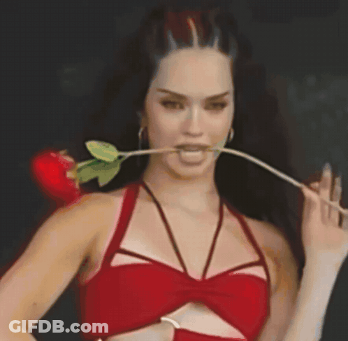 Woman In Red Top With Rose In Mouth GIF