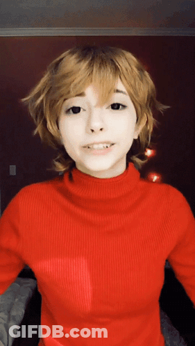 Woman In Red Turtleneck And Blonde Wig GIF