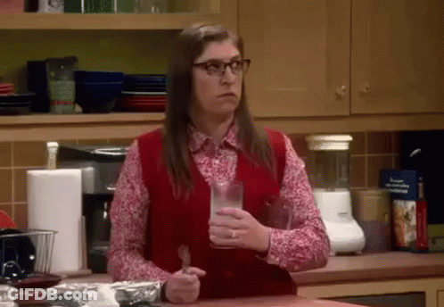 Woman In Red Vest Holding Milk And Fork GIF