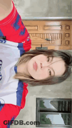 Woman In Red White Blue Shirt By Door GIF