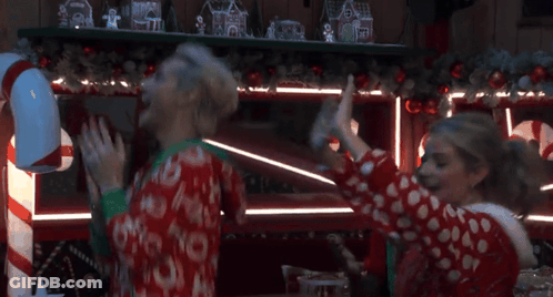 Woman In Red-White Polka Dot Sweater Arms Raised GIF