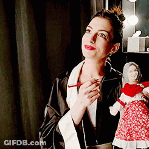 Woman In Robe Holding Doll GIF