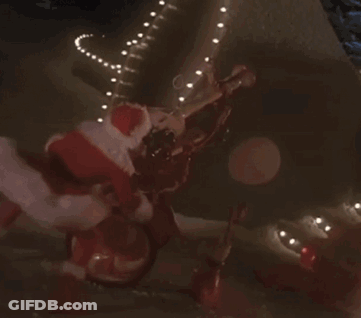 Woman In Santa Costume Riding Bike At Night GIF