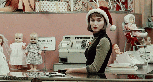 Woman In Santa Hat Behind Mommy's Baby Sign GIF