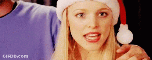 Woman In Santa Hat Holding Christmas Present GIF