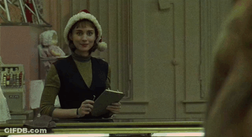 Woman In Santa Hat Looking At Herself GIF