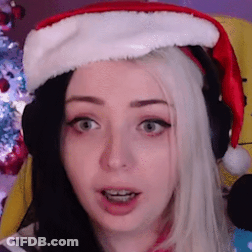 Woman In Santa Hat Making Funny Face GIF
