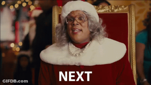 Woman In Santa Hat With Word Next GIF
