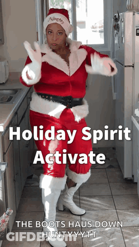 Woman In Santa Suit Dancing In Kitchen GIF