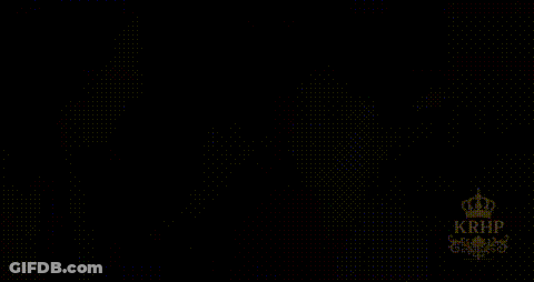 Woman In Sari With Crown In Front Of Chandelier GIF