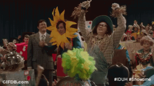 Woman In Scarecrow Costume Holding Scarecrow GIF