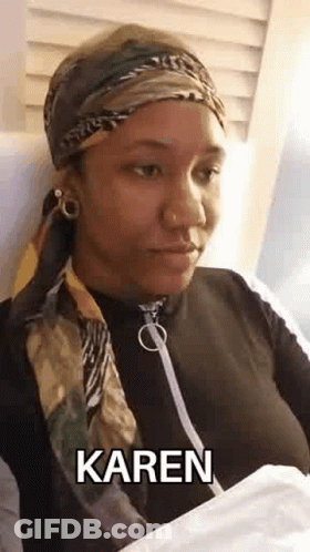 Woman In Scarf, Headband, And Bandana Sitting In Chair GIF