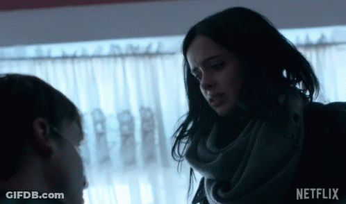 Woman In Scarf Talks To Man In Front Of Window With Netflix Logo GIF