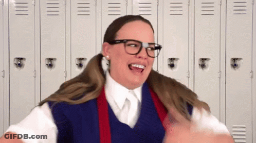 Woman In School Uniform Making Funny Face By Lockers GIF