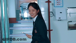 Woman In School Uniform Walking Down Stairs With Cell Phone GIF