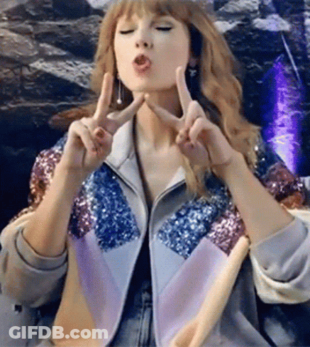 Woman In Sequin Jacket Making Peace Sign GIF
