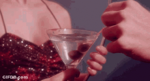 Woman In Sequined Dress Holding Martini GIF