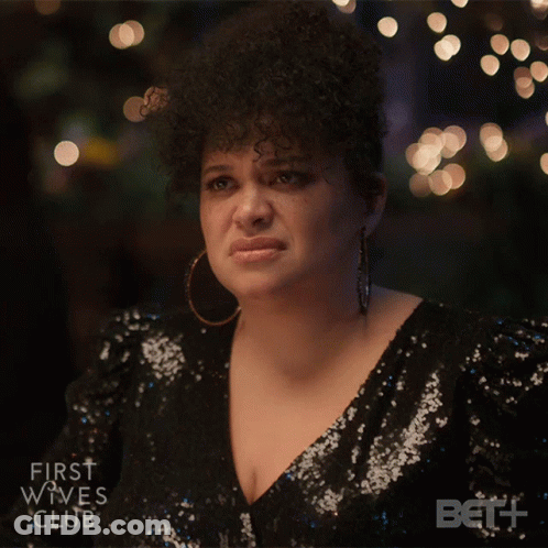 Woman In Sequined Dress Looks Sad GIF