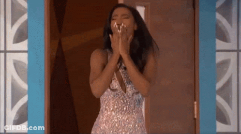 Woman In Sequined Dress Standing In Doorway With Hands On Face GIF