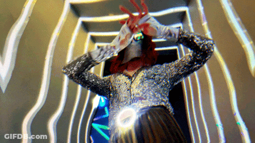 Woman In Sequined Jacket And Gloves With Blood On Hands GIF