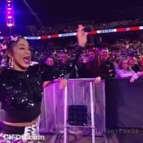 Woman In Sequined Top With Raw Sign GIF