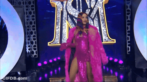 Woman In Silver Dress Dancing In Front Of Balloons GIF