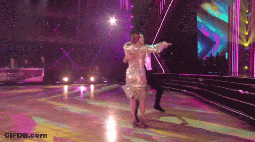 Woman In Silver Dress Dancing With Man GIF